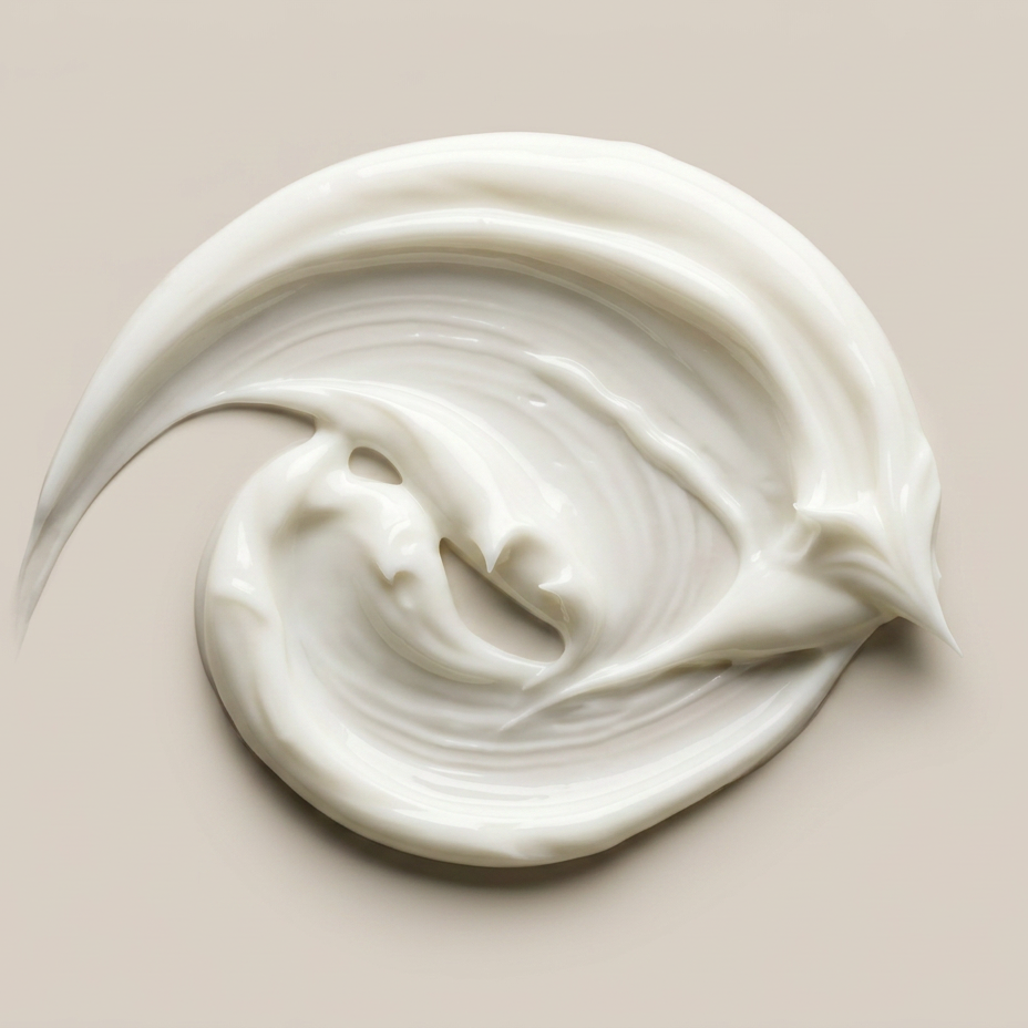 A swirl of thick, creamy white cosmetic cream or lotion on a solid beige background.