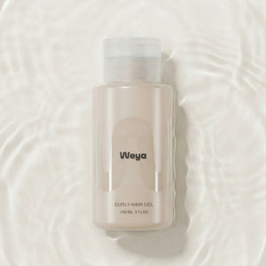 Weya curly hair gel bottle on a textured water background