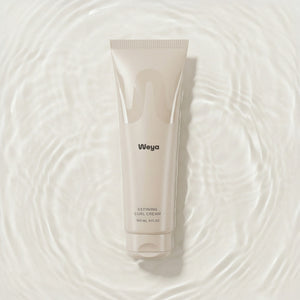 Weya defining curl cream tube on a water background