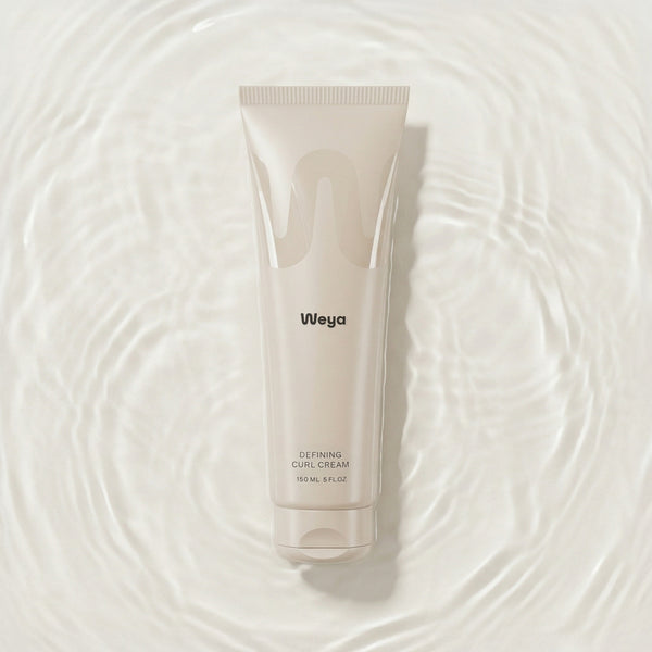 Weya defining curl cream tube on a water background