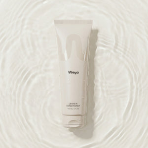 Weya leave-in conditioner tube on a textured water background