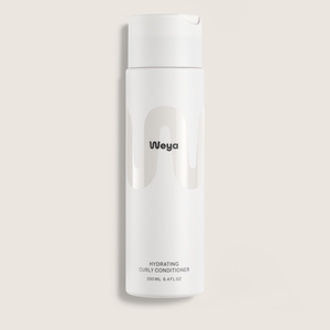 A white cylindrical bottle of Weya Hydrating Curly Conditioner, featuring a minimalist design with a black logo and text, set against a solid light beige background.