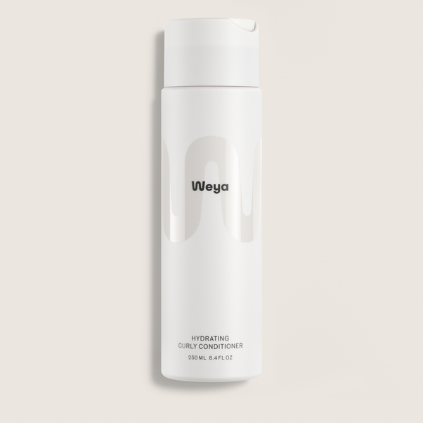 A white cylindrical bottle of Weya Hydrating Curly Conditioner, featuring a minimalist design with a black logo and text, set against a solid light beige background.