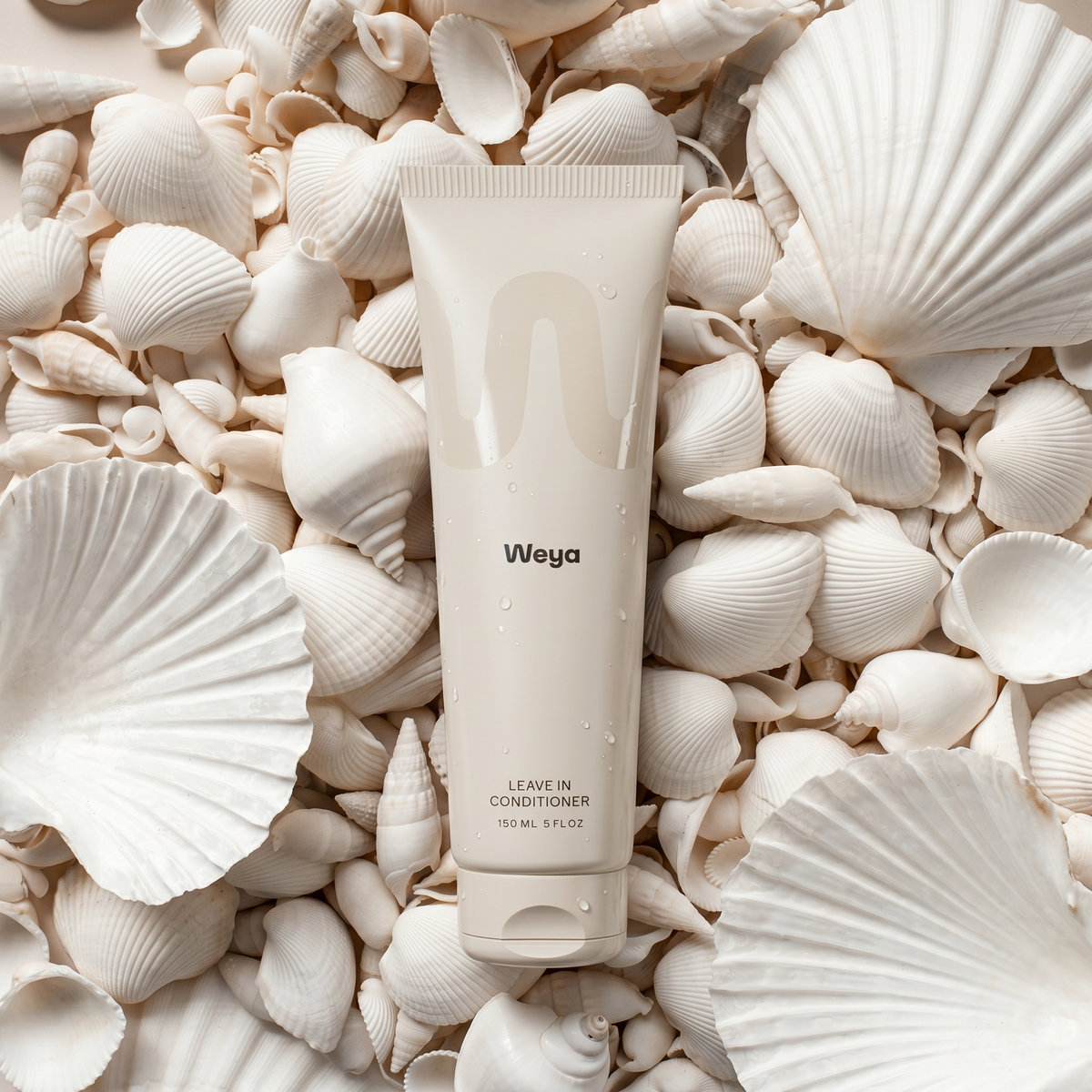 Weya leave-in conditioner tube surrounded by seashells