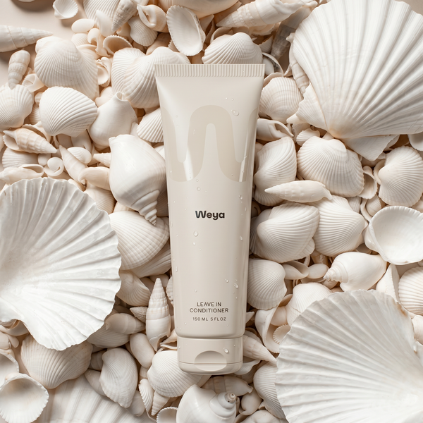 Weya leave-in conditioner tube surrounded by seashells